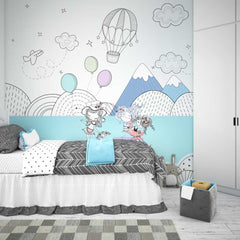 Cozy bedroom with whimsical wall mural and cartoon girls, featuring a bed with white comforter and gray blanket